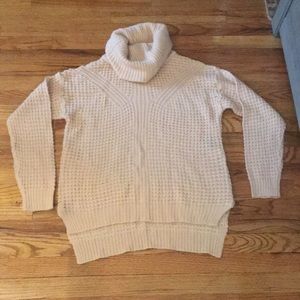 Chunky,cowl neck sweater w/ side zippers at hips.